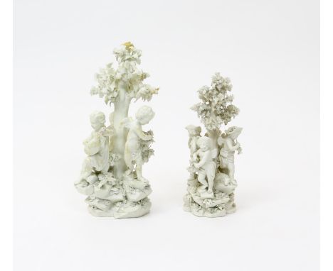 Two Derby biscuit porcelain figure groups  c.1775, one of three putti seated on a rocky base around an oak tree, one playing 