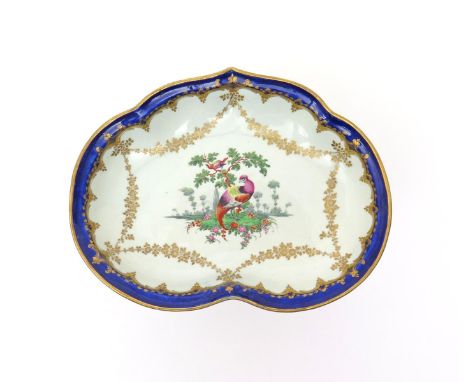 A Worcester kidney-shaped dessert dish  c.1780, the well painted with a fancy bird perched on a grassy mound with a further b