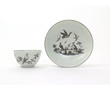 A Worcester teabowl and saucer  c.1760, printed in black, the teabowl with a single bird perched on a branch with two others 