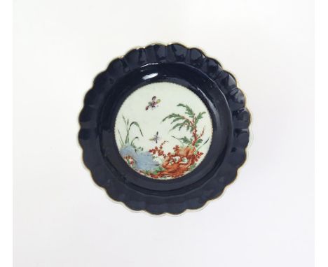A Worcester dessert plate  c.1770, with scalloped edge, the well painted with insects in flight above an Oriental garden scen
