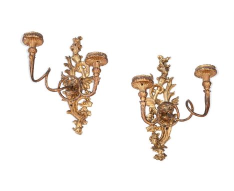 A PAIR OF CARVED GILTWOOD TWIN LIGHT WALL APPLIQUES  MID 18TH CENTURY, POSSIBLY ITALIAN  Each with backplate with flaming urn