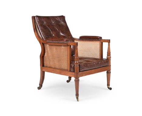 A GEORGE III MAHOGANY LIBRARY BERGERE ARMCHAIR  ATTRIBUTED TO GILLOWS, CIRCA 1810 With buttoned leather loose cushions 93cm h
