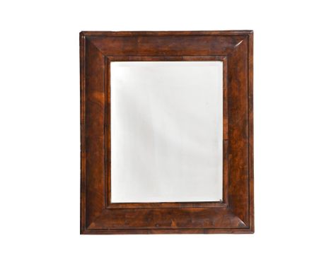 A WILLIAM III FIGURED WALNUT 'CUSHION' FRAMED MIRROR CIRCA 1700  89cm high, 76.5cm wide  Condition Report:  There are scratch
