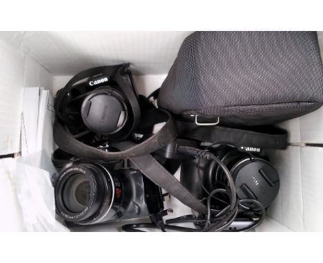 A box of mixed digital camera spares including Canon 