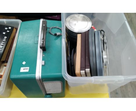 A Bell &amp; Howell movie projector together with a box of accessories 