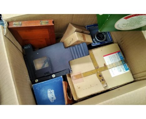 A box of mixed camera accessories including Ross Resolux and enlarger mounts etc, together with a Baker of London slide micro