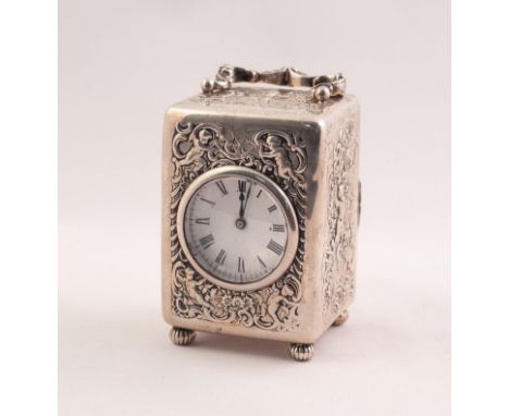 EDWARDIAN SILVER CASED CARRIAGE CLOCK, THE CIRCULAR WHITE ENAMEL DIAL WITH ROMAN HOUR NUMERALS FRAMED WITHIN A SURROUND REPOU