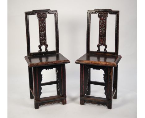 PAIR OF ANTIQUE CHINESE CARVED AND DARK STAINED ELM MARRIAGE CHAIRS, each with scroll and floral carved solid splat to the mo