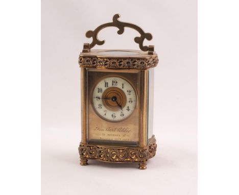 CIRCA 1900 FRENCH SERPENTINE CORNICHE CASED BRASS CARRIAGE CLOCK with pierced rocaille-work appliques, the gilt brass enclose