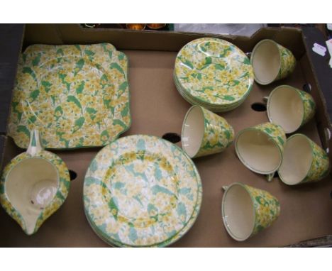 A yellow floral ducal part tea set to include 6 trio's. cake plate and milk jug 