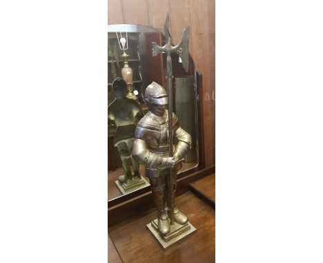Very large cast metal fireside knight holding a poker in axe form, height 85cm. 