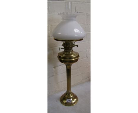 Brass oil lamp with column support, complete with chimney and white glass shade.
