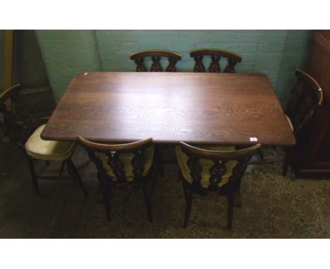 Oak dining table and set of six Ercol dining chairs, table size 75cm x 145cm x 75cm in height. 