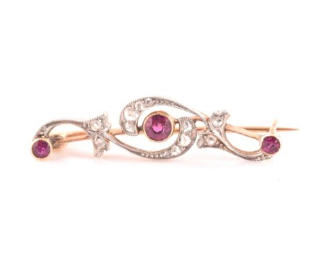 A late 19th / early 20th century diamond and ruby bar brooch, the scrolled mount inset with old rose-cut diamonds, with three