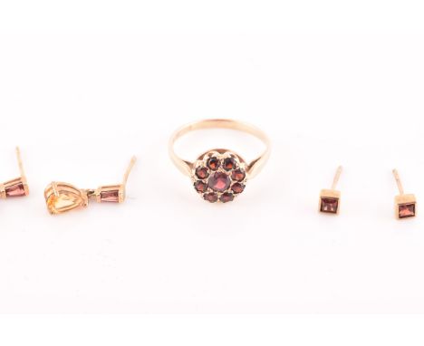 A 9ct yellow gold and garnet floral cluster ring, pave set with mixed round-cut red garnets, size N, together with a pair of 