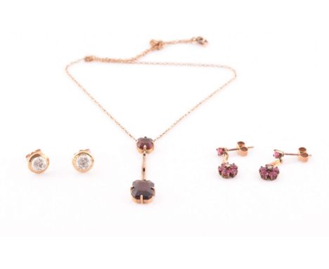 An early 20th century 9ct yellow gold and garnet drop pendant necklace, together with a pair of yellow metal, ruby, and and d