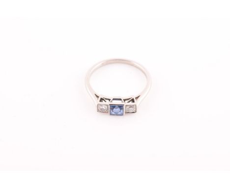A diamond and sapphire ring, set with a fancy square-cut sapphire, flanked with two round brilliant-cut diamonds, of approxim
