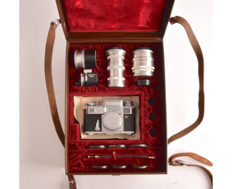 A boxed USSR Russian Kiev 35mm camera and lens set of political interest, in a fitted box together with several lens, filters