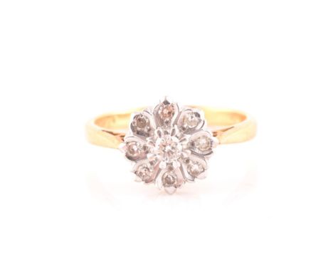 An 18ct yellow gold and diamond floral cluster ring, set with nine round brilliant-cut diamonds in a daisy design, ring head 