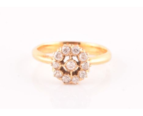 A yellow metal and diamond target cluster ring, centred with a round brilliant-cut diamond within an outer halo border of rou