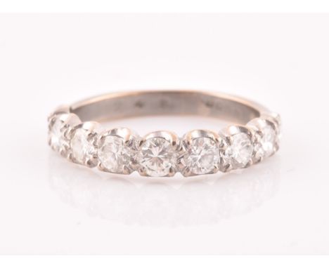 An 18ct white gold and diamond ring, set with nine graduated round-cut diamonds, the largest central stone approximately 0.20