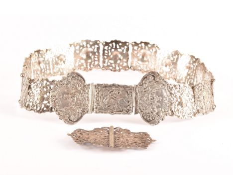 A 19th century Continental white metal belt, with pierced and repose decoration depicting scenes of figures to the buckle and