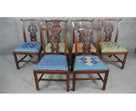 A set of six 19th century mahogany dining chairs with carved and pierced splat backs above drop in tapestry seats on square s