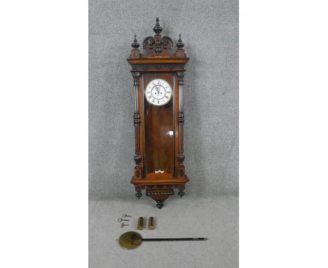 A 19th century German walnut Vienna regulator wall clock with white enamel dial with black Roman numerals. With pendulum, key