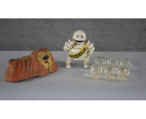 A vintage cast iron painted Michelin man figure along with a rubber Dougal from the Magic Roundabout and six miniature clear 