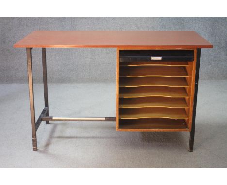 A mid century vintage teak desk on a metal frame with integral tambour fronted filing pedestal. H.74 w.122 D.60 cm. 