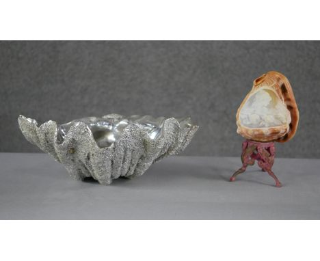 A carved vintage conch shell light with a female portrait and flower decoration on a gilt metal griffin stand along with a mo