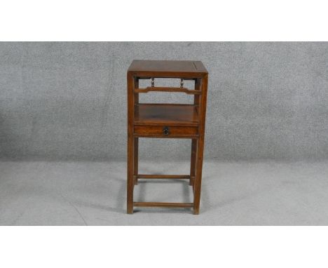 A 19th century Chinese teak urn stand or lamp table on square supports united by under tier fitted with a drawer. H.84 W.42 D