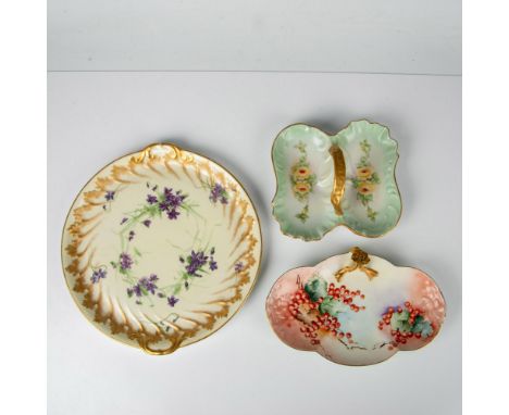 A red cloud-like platter with painted cranberries and a gold stem handle, a green double-sided platter with yellow roses and 