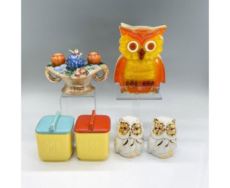 Bright cheerful vintage tableware items in orange, yellow and turquoise coloration. The owl napkin holder is Lucite and the o