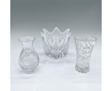 A collection of clear small flower vases with a floral motif. Includes a bulbous shape with etched snowdrop flowers, a flared