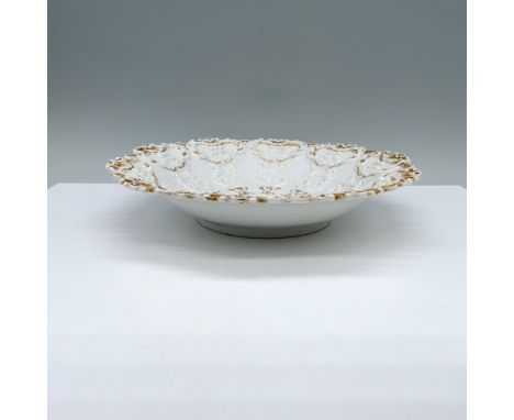 An exquisite white plate, adorned with intricate floral and abstract patterns, beautifully framed by a luxurious golden rim. 