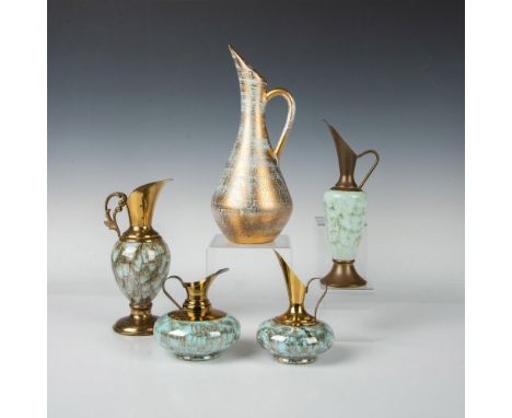 A set four turquoise colored ceramic pitchers embellished with a root art pattern complemented by a large gold-colored pitche