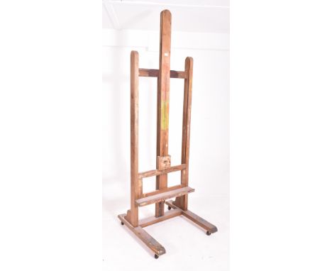 A very large 20th century wooden floor standing artist's easel. Measures approx. 225cm x 74cm x 80cm not extended.&nbsp;