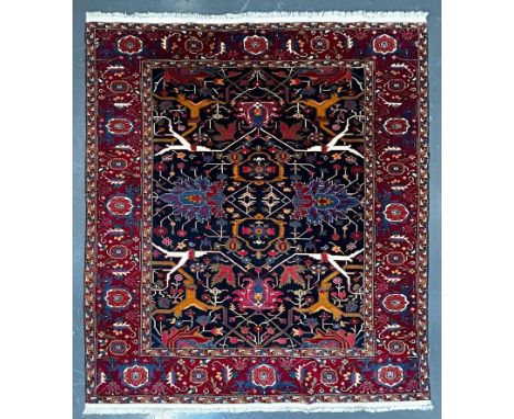 A contemporary Persian Islamic Heriz fine wool floor carpet rug. The rug of rectangular form with central panel intricately d