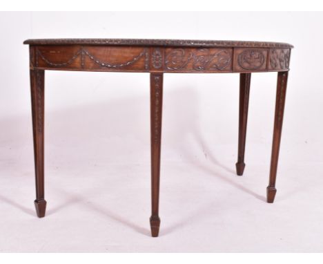 An Adams Revival mahogany demi-lune console hall table. The table having a straight top with carved chamfered edges over an i