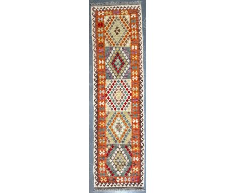 A contemporary Anatolian Turkish Kilim floor carpet runner rug. The runner having a central panel with five rhombus shaped mo