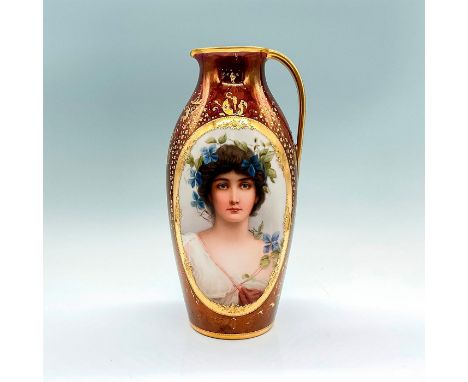 A stunning mahogany-luster pitcher with a hand-painted gilded-gold handle and gilt floral accents. Adorn with a portrait of a