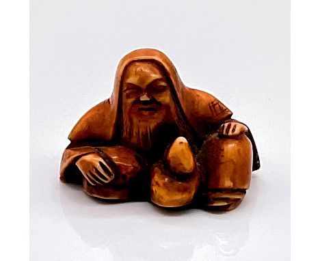 Carved figure in imitation of a Japanese netsuke. A figure of a bearded man with a calabash. Dimensions: 1.75"L x 1.25"W x 1.