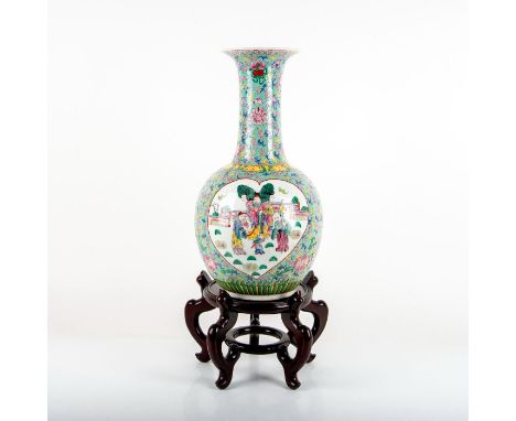 Tall porcelain vessel decorated with hand painted enamel floral motif and a Qing Dynasty saga scene of the Sanxing Deities. S