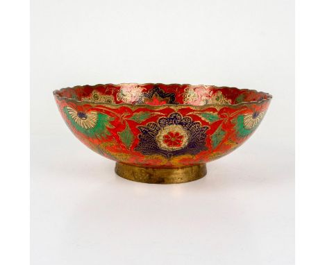 A beautiful brass bowl featuring an ornate enamel peacock in a rainbow of colors on a rich red ground; gilded accents along t