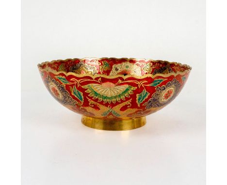 A beautiful brass bowl featuring an ornate enamel peacock in a rainbow of colors on red ground; gilded accents around the rim