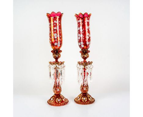 Opulent pair of candlestick holders with opalescent cranberry coloration. Elaborate enamel floral decorations with gold gilt 