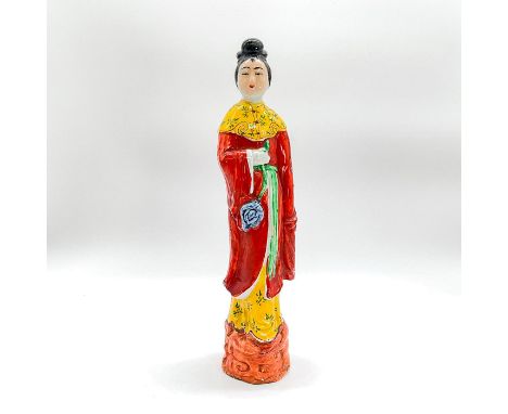 Ceramic glazed figure of a lady standing on an orange base in a red robe and yellow and green skirt, holding a blue flower. D