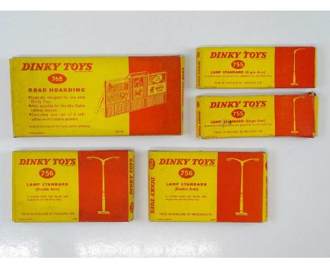 A group of DINKY accessories comprising 2x 755 single lamp standards, 2x 756 double lamp standards and a 765 Road Hoarding - 