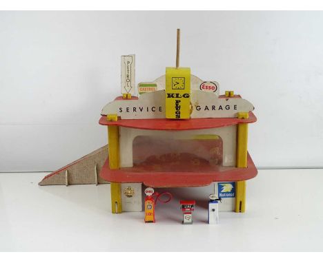 A vintage 1960s/70s wooden built toy garage, together with a group of other plastic toys including a fire engine and several 